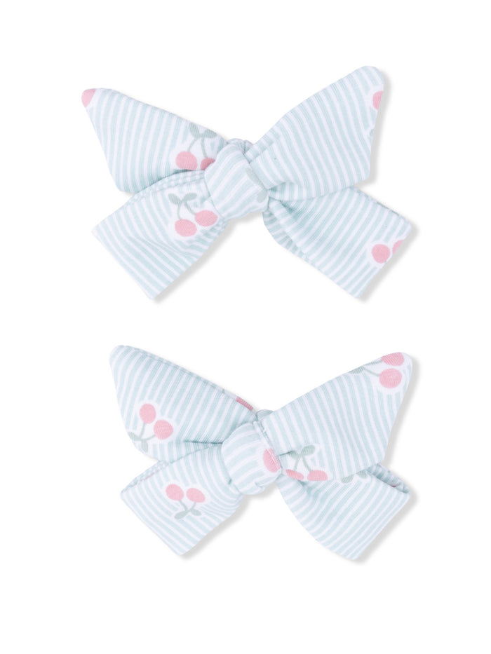 Light blue striped hair bows with pink cherry patterns, arranged in a pair.