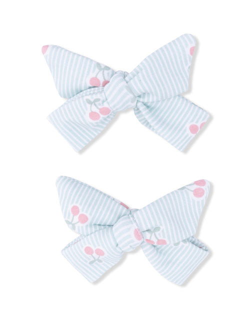 Light blue striped hair bows with pink cherry patterns, arranged in a pair.