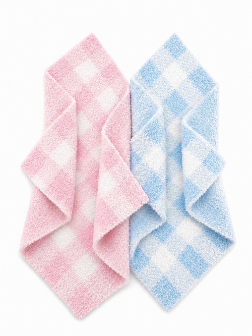 Pink and blue checkered washcloths stacked in a diagonal arrangement against a white background.