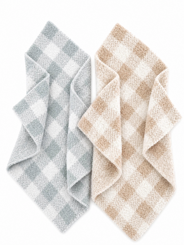 Two cozy checkered kitchen towels in blue and beige, neatly folded and overlapping on a white background.