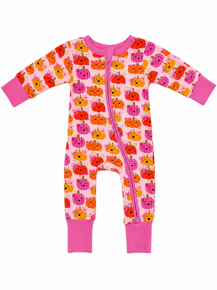 Colorful baby onesie with pumpkin print and pink accents, featuring long sleeves and a front zipper.