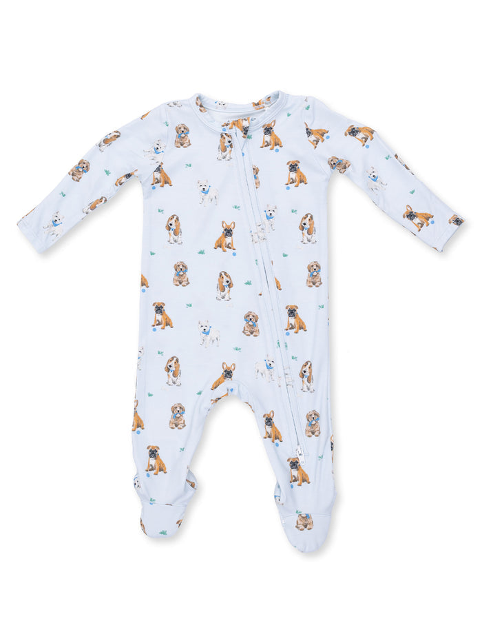 Baby pajamas featuring an all-over print of playful dogs on a light blue background.