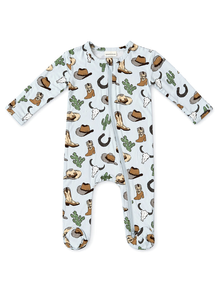 Light blue baby onesie with cowboy-themed print, including hats, boots, cacti, and steer skulls.