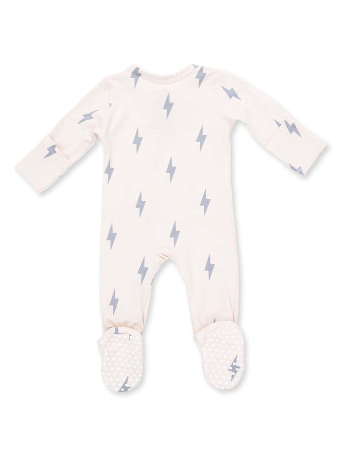 Cream-colored baby onesie with gray lightning bolt patterns and dotted footed bottoms.