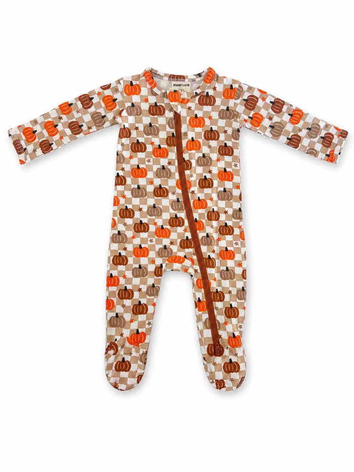 Toddler pajamas featuring a pumpkin pattern in orange, brown, and cream colors with a front zipper closure.