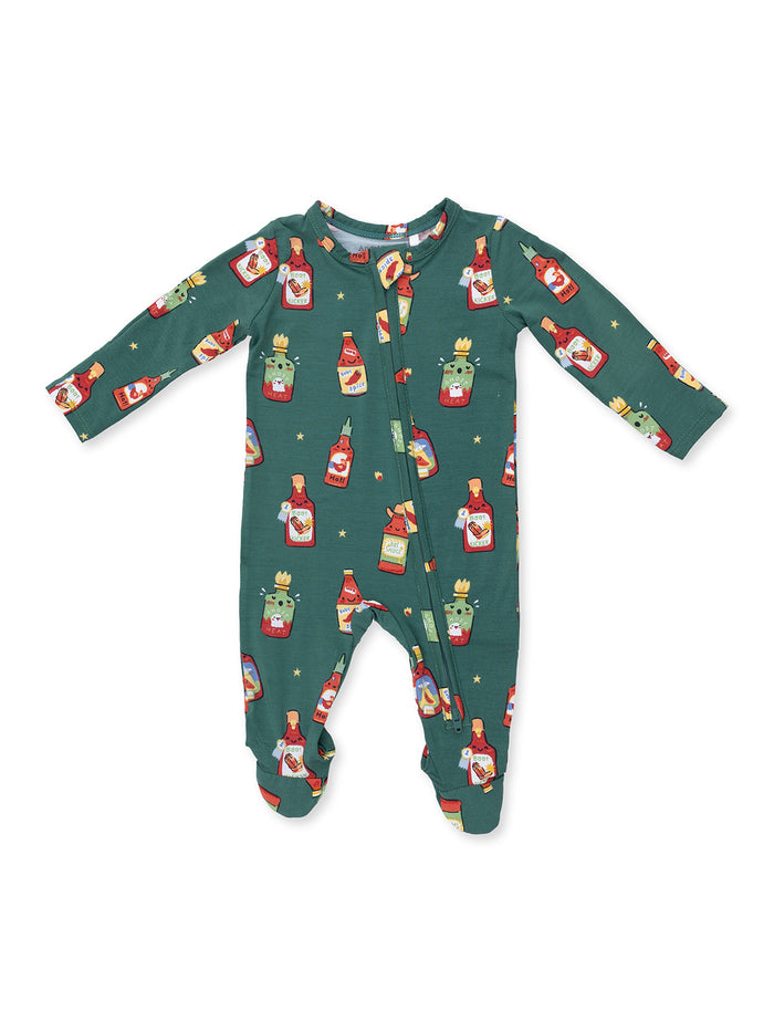 Green baby onesie featuring colorful cartoon food bottles and spicy themes.