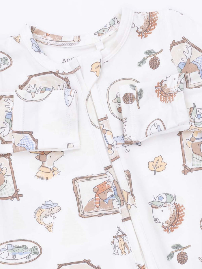 Child's pajama set featuring fun animal prints, including bears and fish, on a soft white fabric background.