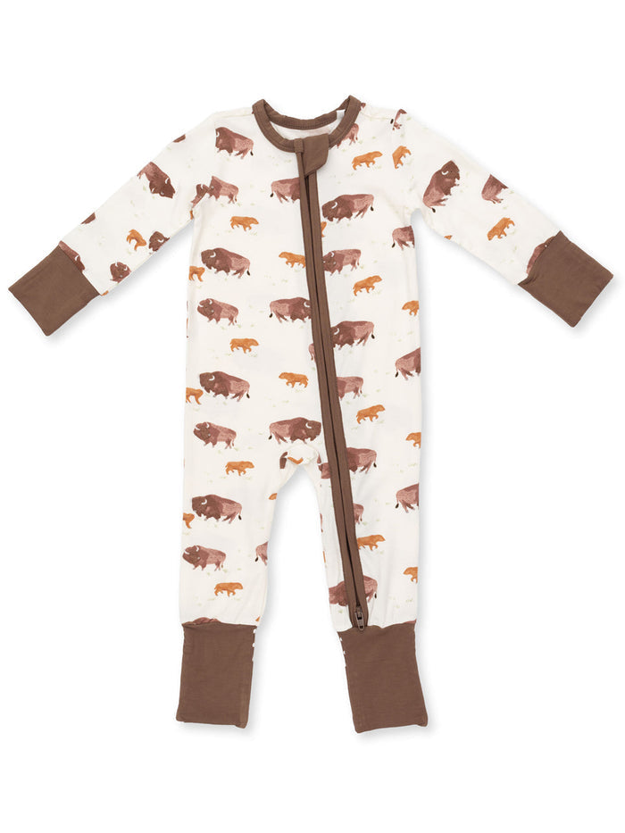 Children's one-piece pajama with brown bison print on cream background and brown cuffs. Zipper closure in front.