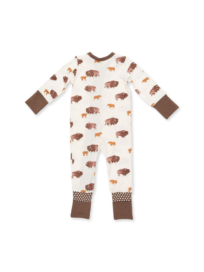 Toddler's onesie featuring a playful bison print in earth tones on a cream background with brown details.