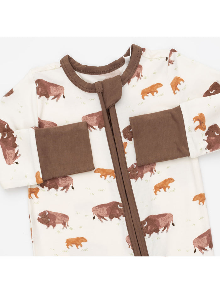 Infant onesie featuring a brown and cream color scheme with a bison pattern and zip closure.