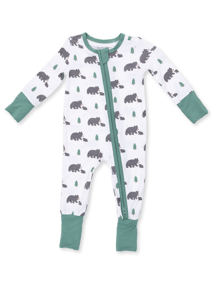 Infant one-piece pajamas with bear and tree print, featuring a green zipper and cuffs.