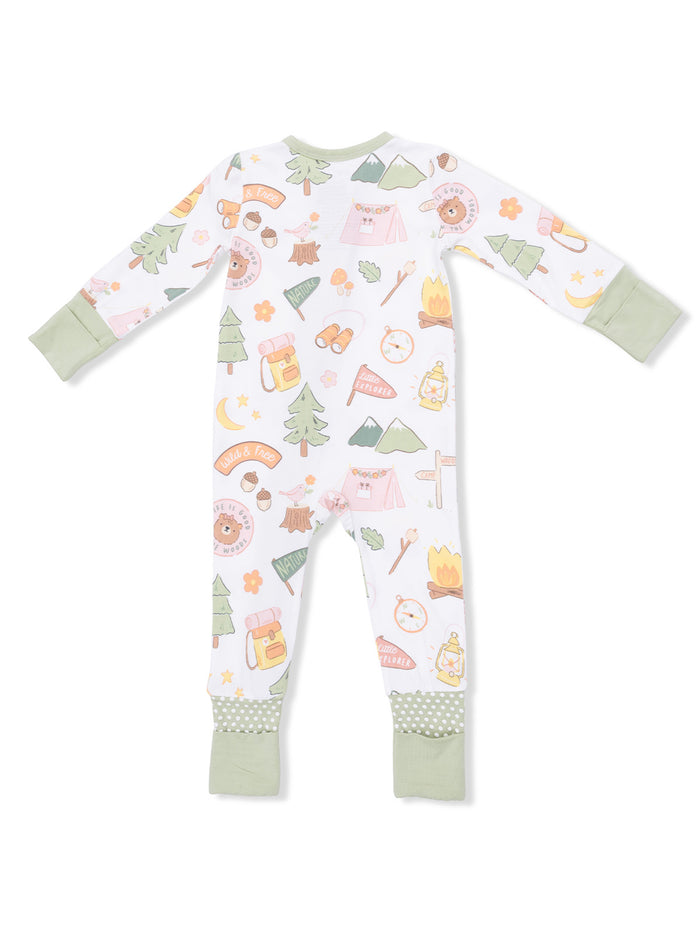 Kid's pajamas with a whimsical camping theme featuring animals, nature, and adventure icons in pastel colors.