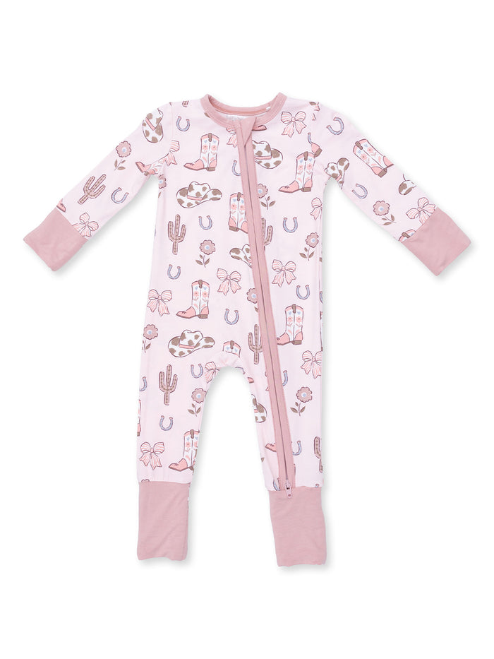 Pink infant pajamas with cowboy and cactus patterns, featuring long sleeves and a front zipper.