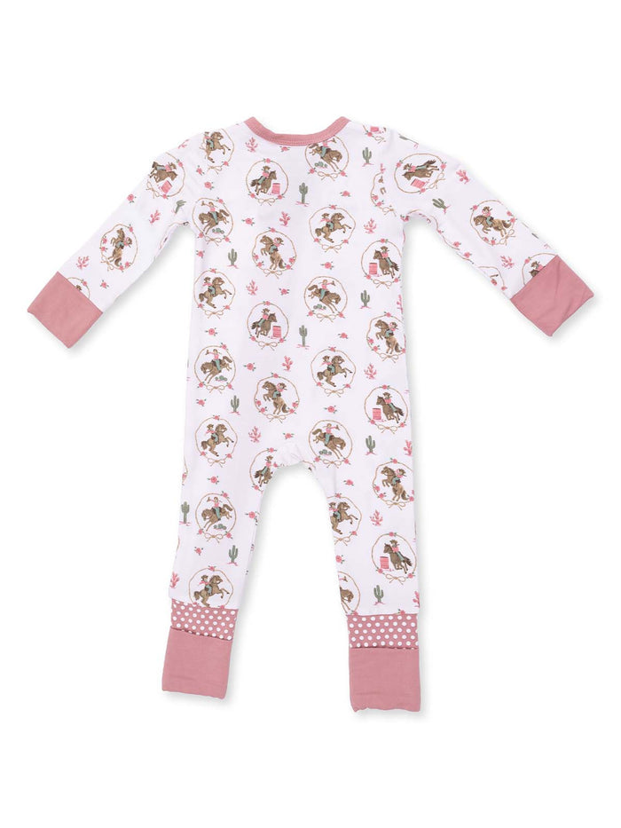White infants’ jumper with playful print of cartoon cowboys and cacti, featuring pink accents and polka-dot cuffs.