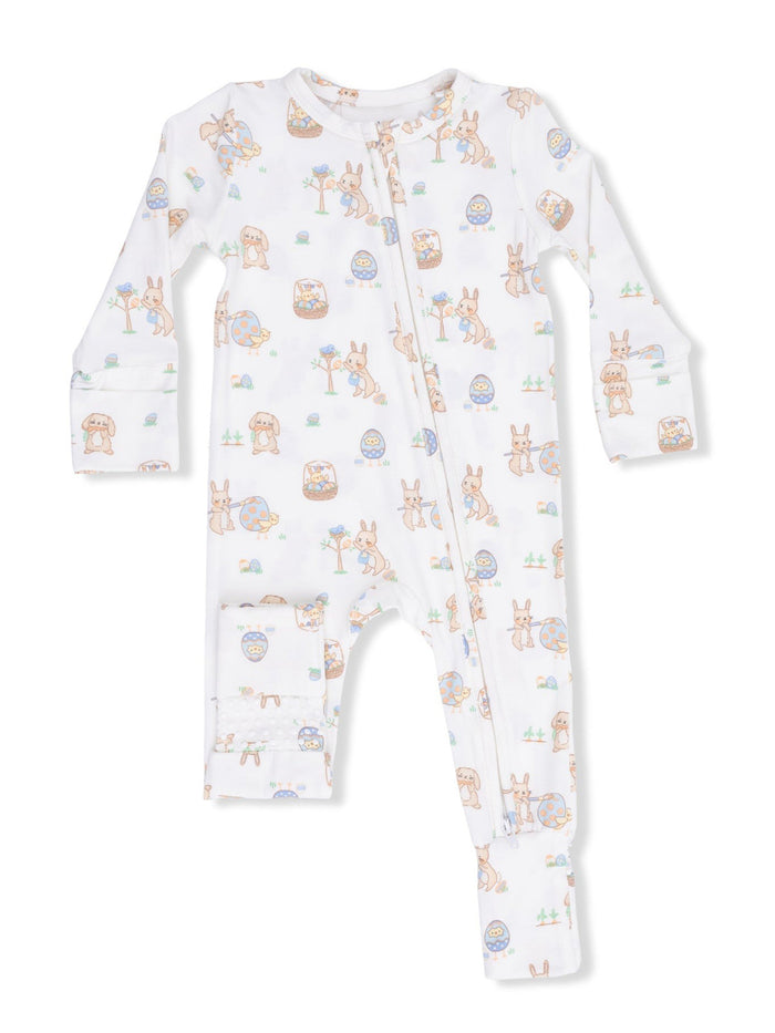 White baby onesie with pastel animal prints, featuring rabbits, eggs, and flowers, with a front zipper closure.