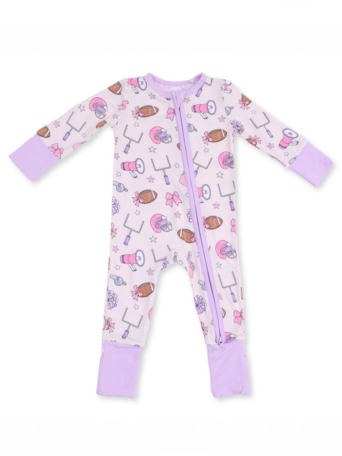 Children's zip-up pajama, light purple with sports and bow patterns. Soft fabric and long sleeves for comfort.