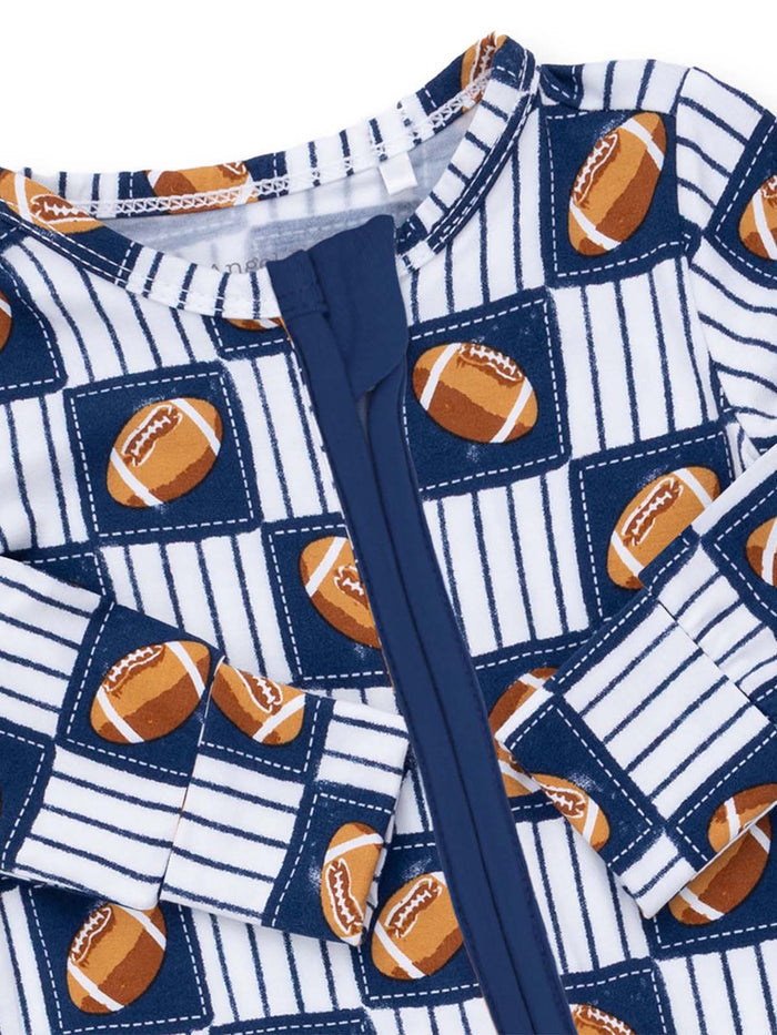 Children's football-patterned pajama suit with a blue zipper and striped design.
