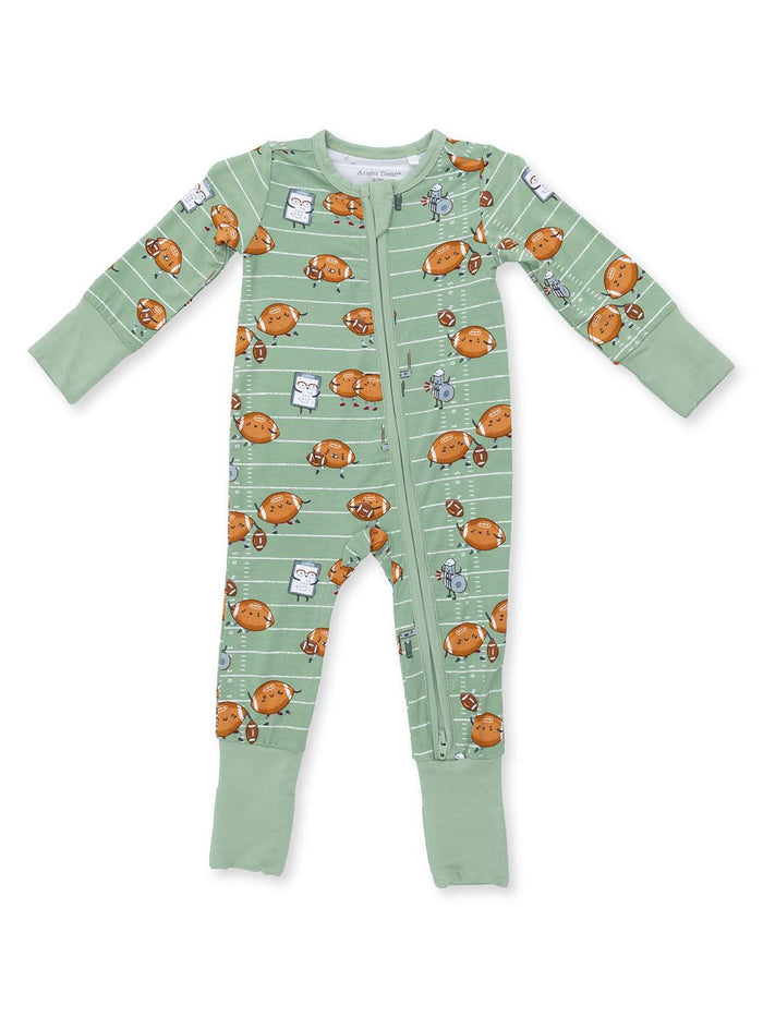 Green baby onesie with cartoon footballs and playful characters on a striped background.