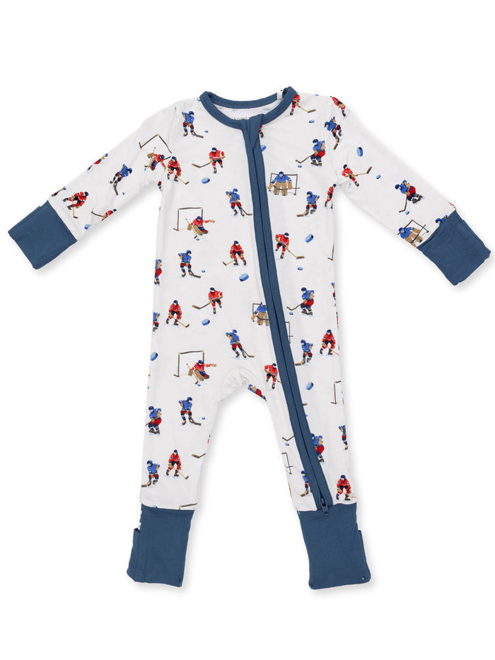 Toddler pajama onesie featuring a playful hockey print with colorful players and sports elements.