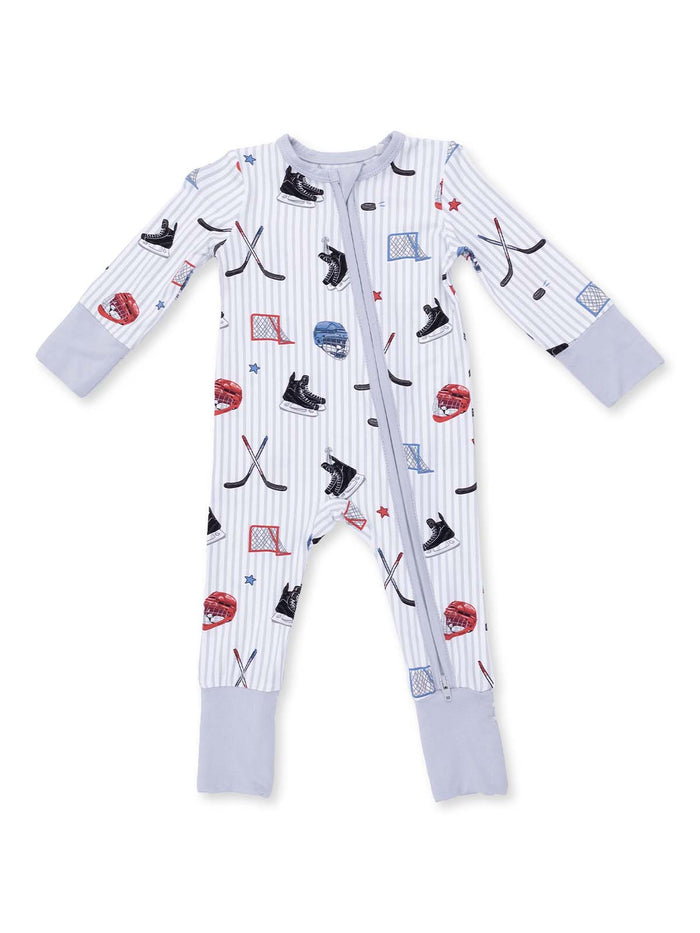 Hockey-themed baby onesie with playful patterns of skates, helmets, and pucks on a light striped background.
