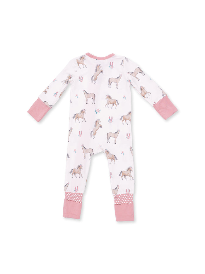 Pink and white unicorn-patterned kids' pajamas, showing the back view with pink cuffs and polka dot accents.