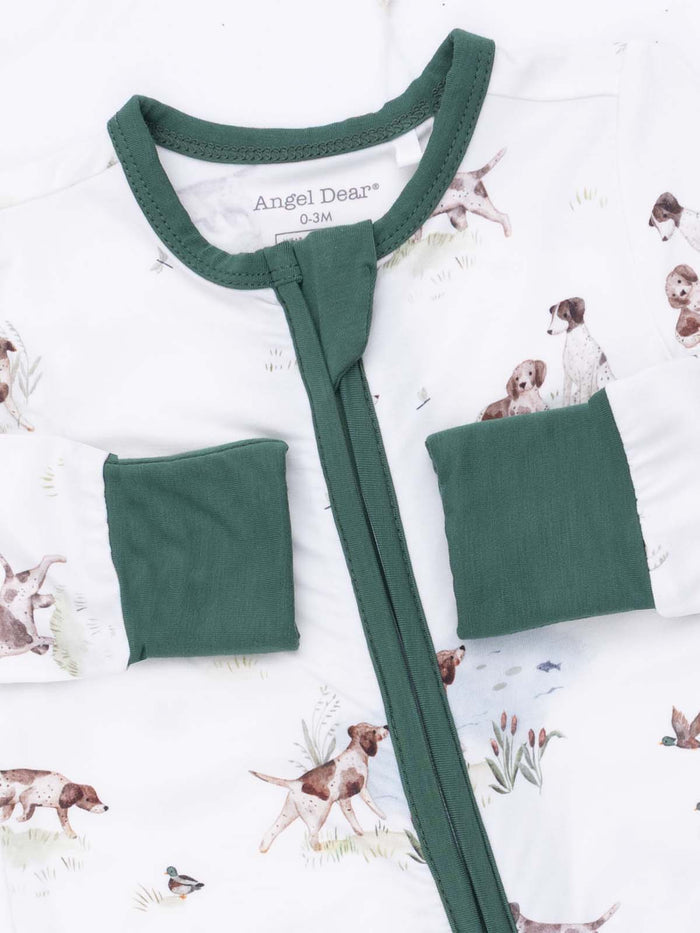 White sleep sack with green trim featuring a playful dog print. Perfect for babies aged 0-3 months.