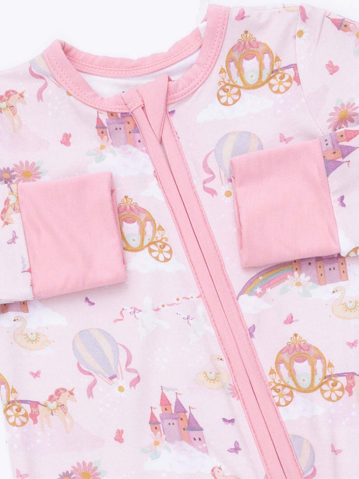 Pink pajamas featuring castles, unicorns, and carriages, ideal for whimsical bedtime adventures.