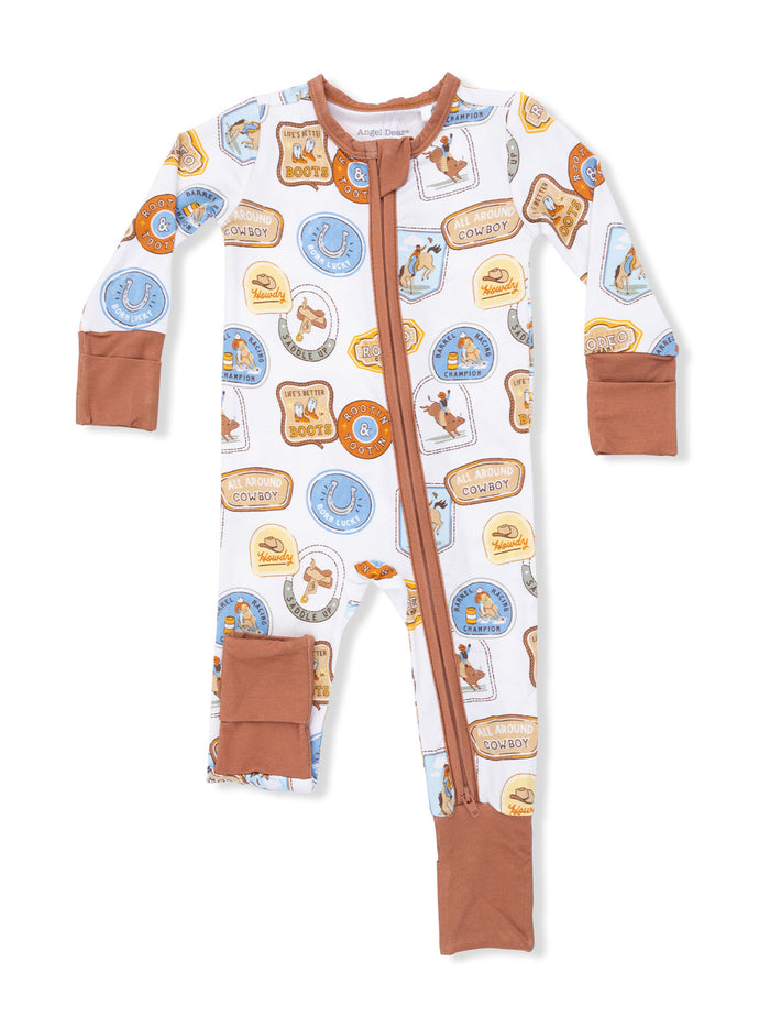 Cowboy-themed toddler pajamas featuring colorful badges and western designs, zip-up front and brown cuffs.
