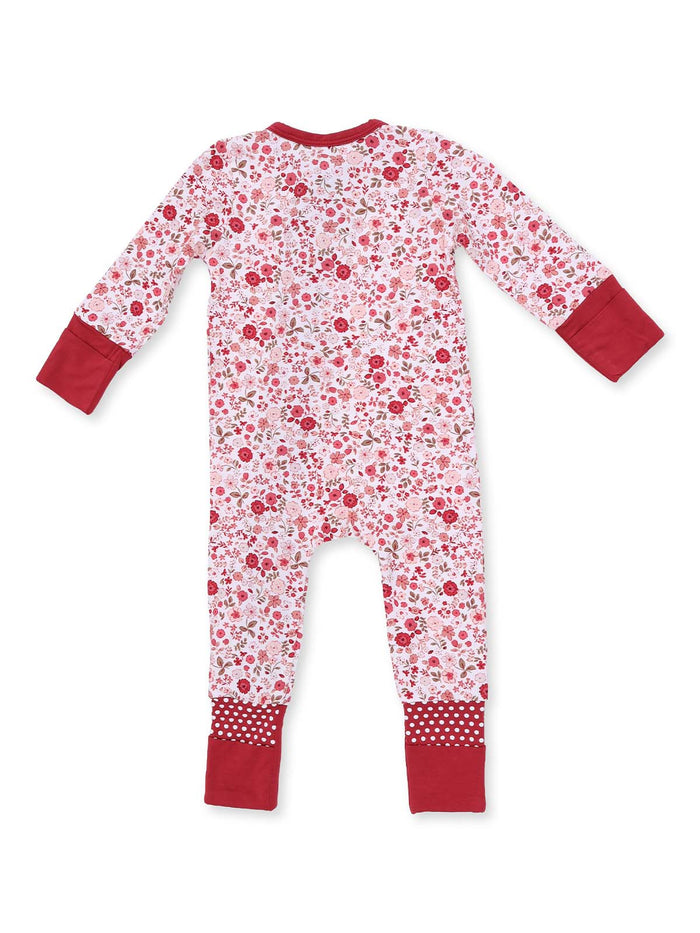 Red floral baby onesie with long sleeves and polka dot cuffs, shown from the back.