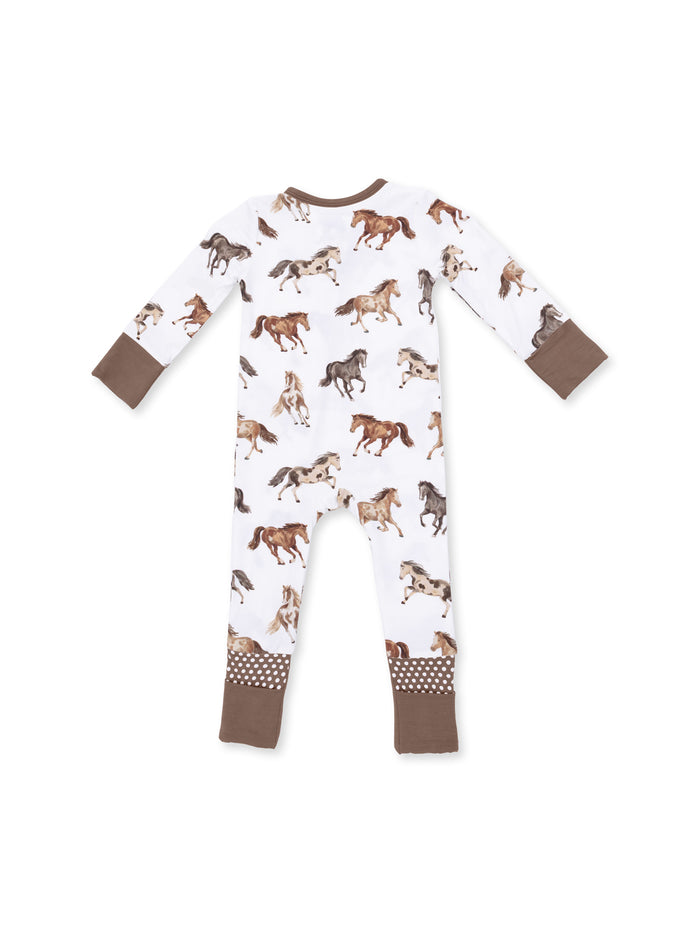 Children's pajama suit featuring playful horse prints with contrasting brown cuffs and polka dot detailing.