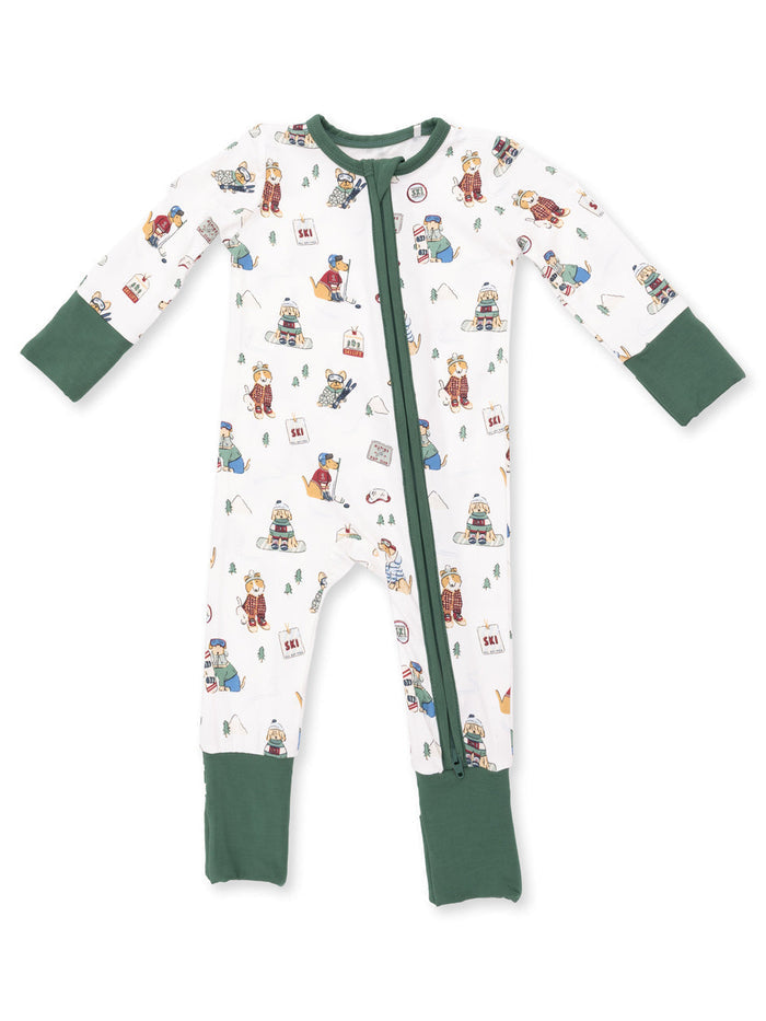 White one-piece pajama showcasing playful winter-themed prints, featuring green sleeves and foot cuffs.