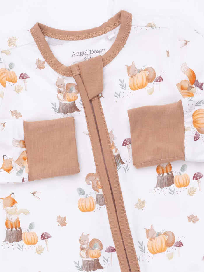 Infant clothing with a whimsical design featuring foxes, squirrels, pumpkins, and autumn leaves.