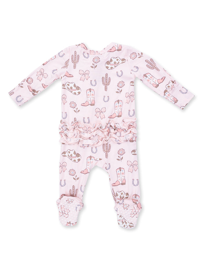 Pink baby outfit with Western prints like boots, cacti, and bows, featuring ruffled details and footed pants.