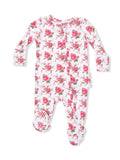 White baby onesie with long sleeves, featuring a pink floral pattern of roses and small flowers.