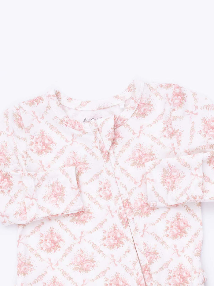 Floral-patterned children's pajama top in soft pink and white, featuring button closure and long sleeves.