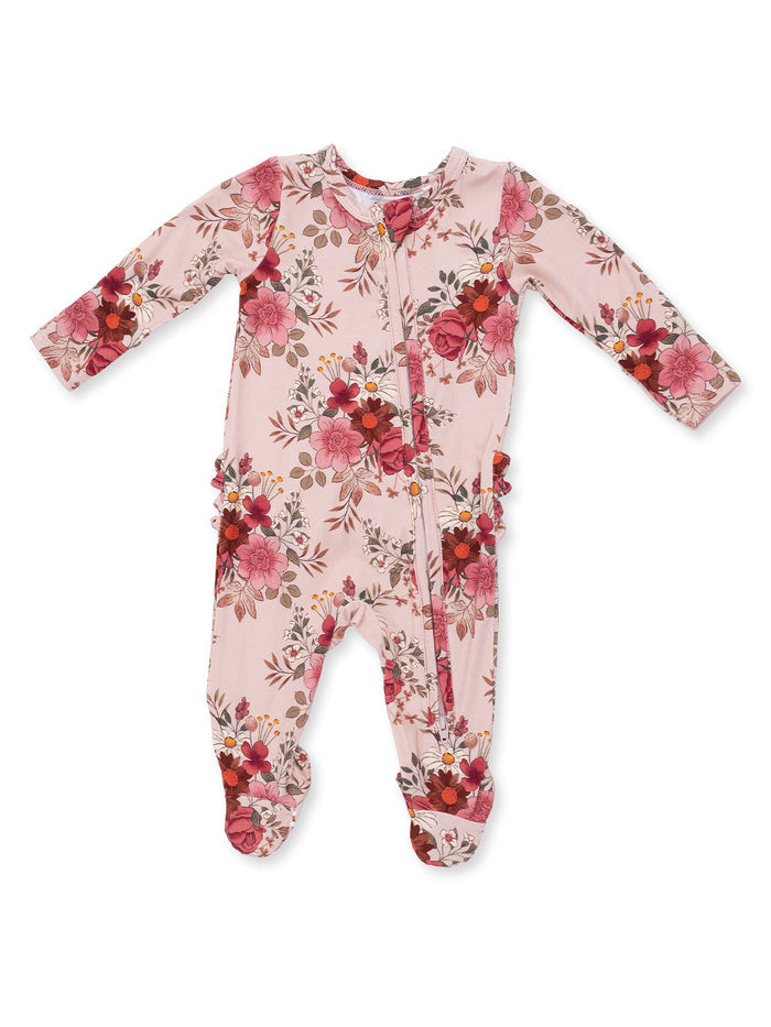 Pink floral onesie with long sleeves and footed legs, featuring ruffles along the sides. Ideal for infants.