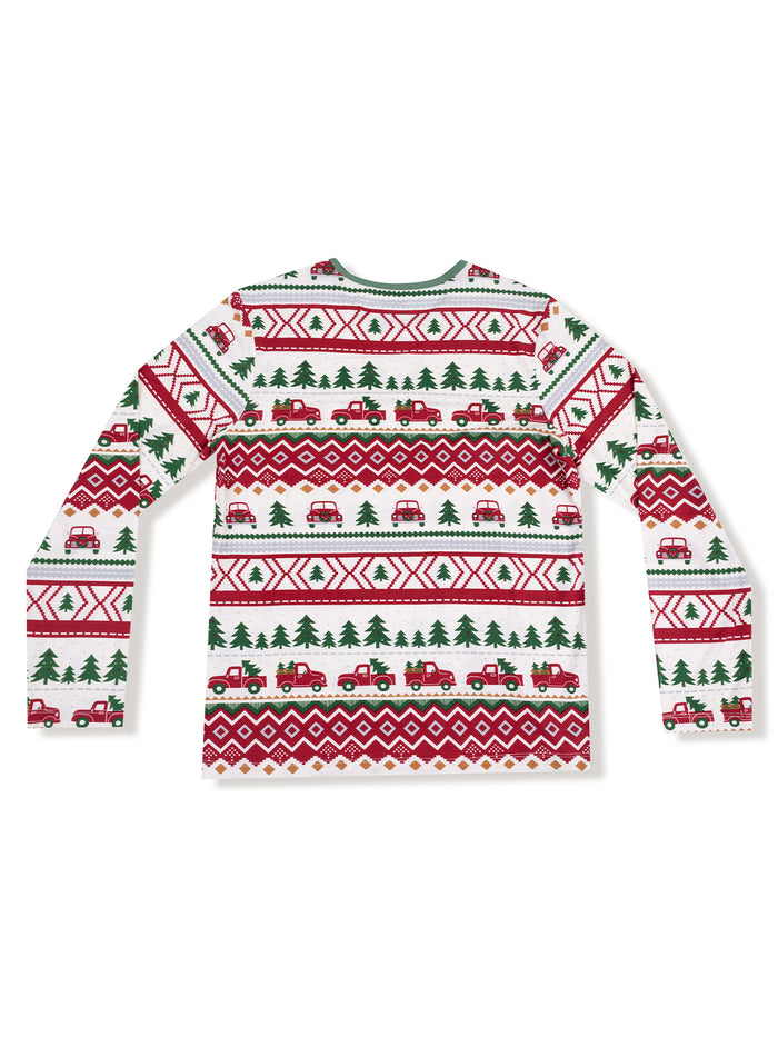 White long-sleeve shirt featuring festive patterns with red trucks and green trees.