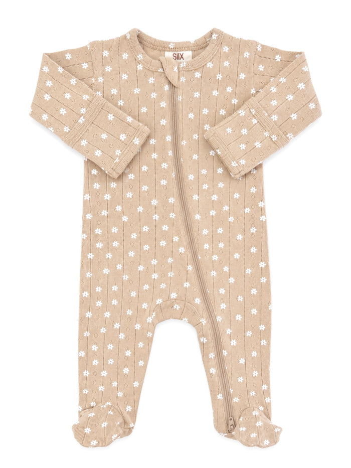 Tan baby onesie with white floral pattern and zip closure. Soft, cozy fabric for infants.