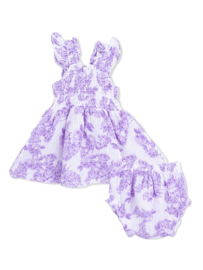 Purple floral infant dress with ruffled straps and matching bloomers, ideal for warm-weather outings.