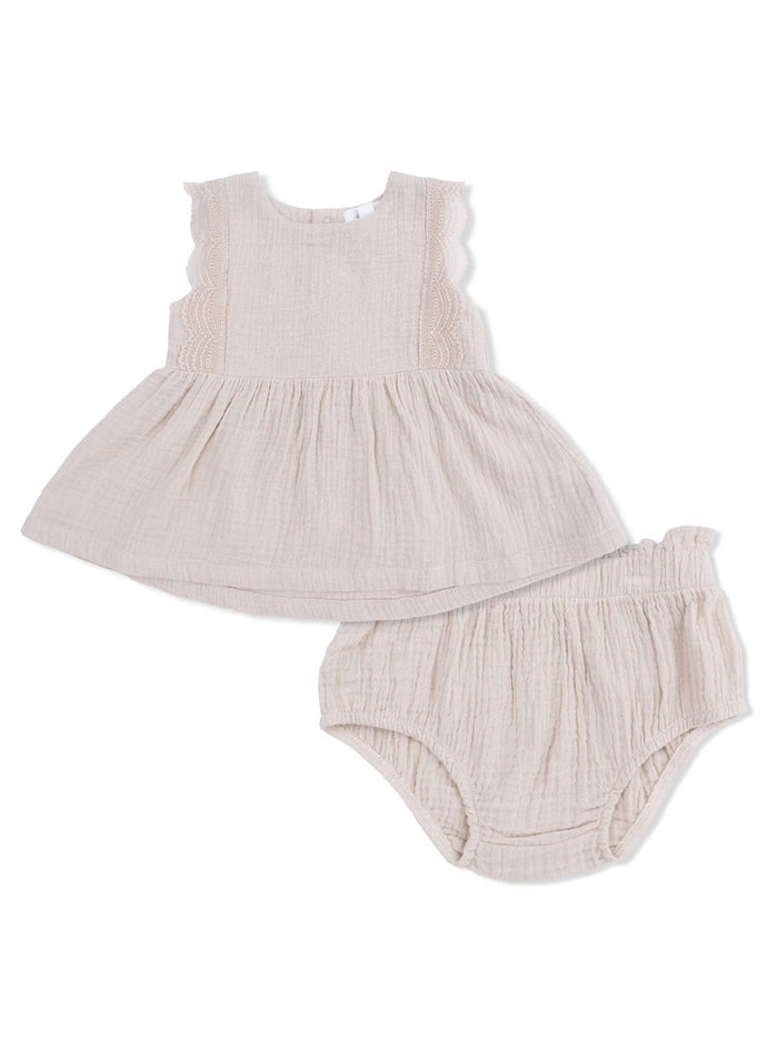 Beige toddler dress and matching bloomers, featuring ruffled sleeves and textured fabric. Ideal for cute summer outfits.