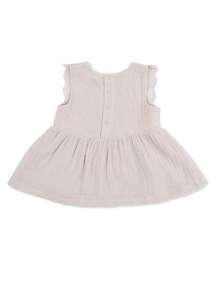 Light beige dress with ruffled sleeves and a flared skirt, featuring a button closure at the back.