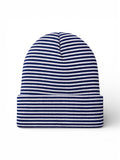 Striped blue and white beanie hat laid flat on a white background.