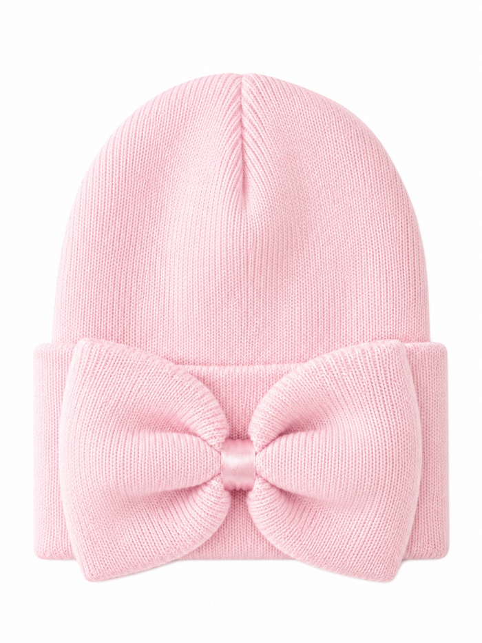 Pink knitted beanie with a large bow on the front, providing a cute and stylish look for cold weather.
