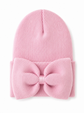 Pink knit beanie with a large bow detail on the front, perfect for stylish warmth in cold weather.