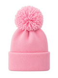 Pink knit beanie with a large pom-pom on top, perfect for winter fashion and warmth.