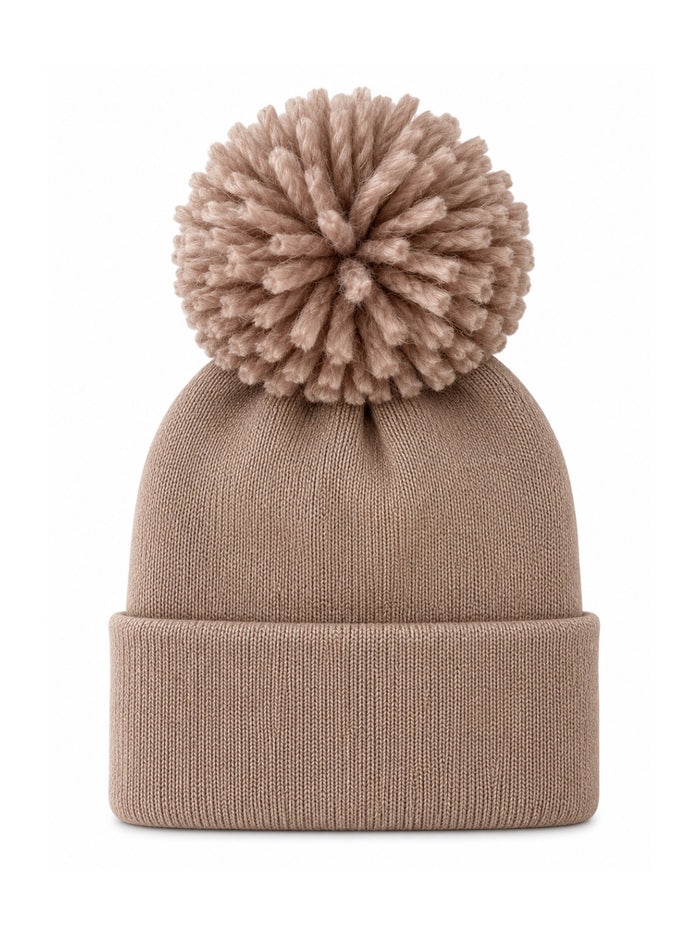 Beige knit beanie hat with a large pom-pom on top, ideal for winter wear.