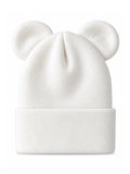 White knit beanie with two round ear-like features on top.