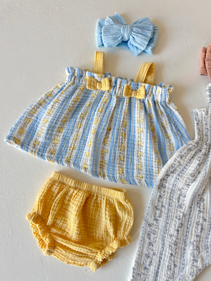 Cute baby dress set with blue and yellow stripes, matching yellow shorts, and a blue bow headband.