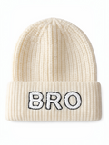 Cream-colored knit beanie with "BRO" embroidered in black on the front.