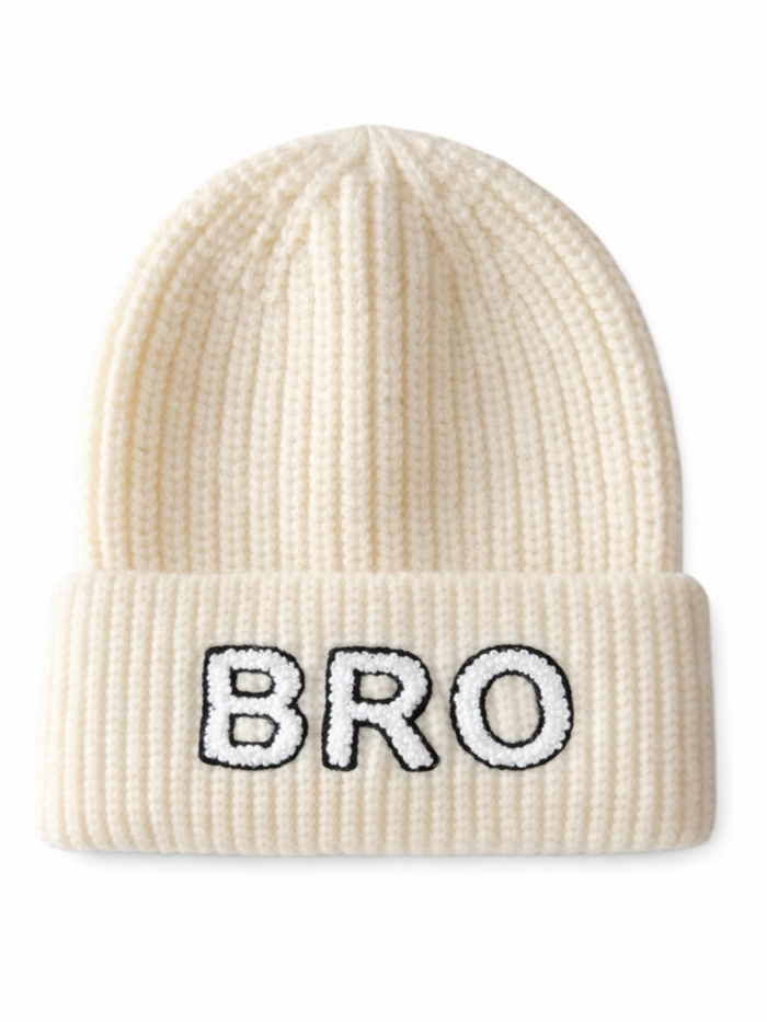 Cream-colored knit beanie with "BRO" embroidered in black on the front.